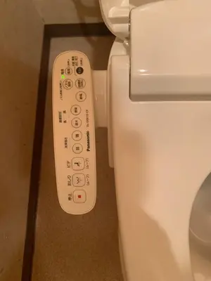 a remote control next to a toilet in a bathroom at North Shinjuku house 5\u99c5\u5f92\u6b69\u570f\u5185\u306e\u5317\u65b0\u5bbf\u306e\u5bb6 in Tokyo