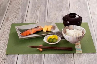 a plate of sushi and a bowl of rice and chopsticks at \u30db\u30c6\u30ebDEN in Tokyo