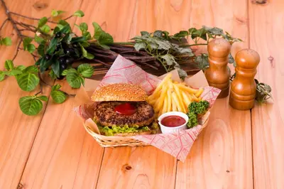 a basket of food with a burger and french fries at \u30db\u30c6\u30ebDEN in Tokyo