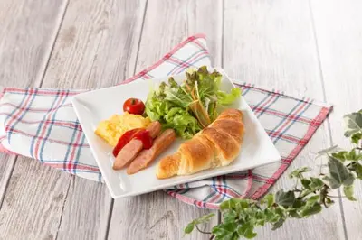 a plate of food with hot dogs and a salad at \u30db\u30c6\u30ebDEN in Tokyo