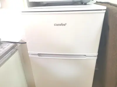 a white refrigerator with a microwave on top of it at HouseKL in Tokyo