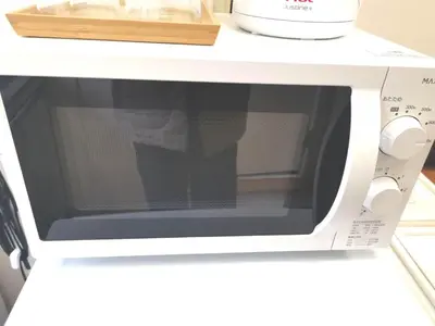 a microwave oven with the door open on a counter at HouseKL in Tokyo