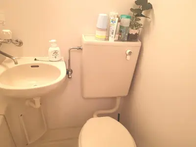 a small bathroom with a toilet and a sink at HouseKL in Tokyo