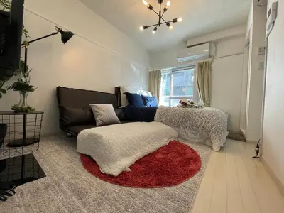 a living room with a couch and a red rug at BEST LOCATED SHINJUKU CENTRAL Full-Furnished APARTMENT 3minWalk to Station1 in Tokyo