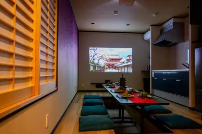 a dining room with a table and green cushioned chairs at Ukiyoan Takasago in Tokyo