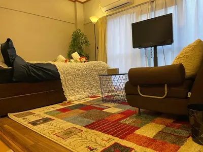 a living room with a couch and a television at Best Shinjuku Modern Full-furnished Family size Apartment4 ONLY 2min to Shinjuku by Train in Tokyo