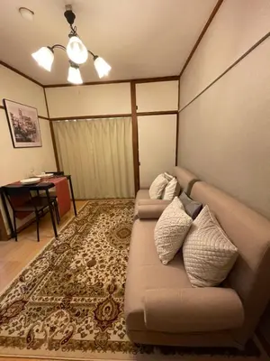 a living room with a couch and a table at Best Shinjuku Modern Full-furnished Family size Apartment4 ONLY 2min to Shinjuku by Train in Tokyo