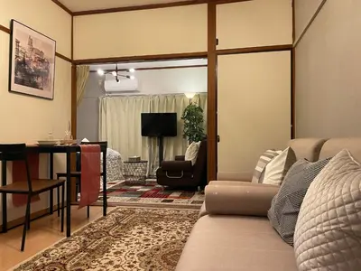a living room with a couch and a table at Best Shinjuku Modern Full-furnished Family size Apartment4 ONLY 2min to Shinjuku by Train in Tokyo