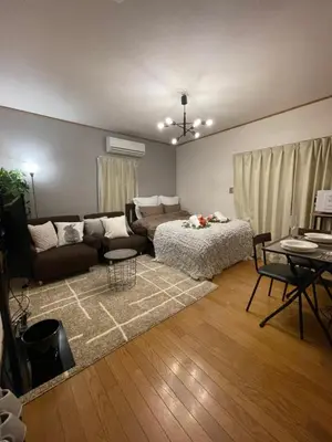 a living room with a couch and a table at Best Shinjuku Modern Full-furnished Apartment1 ONLY 2min to Shinjuku by Train in Tokyo