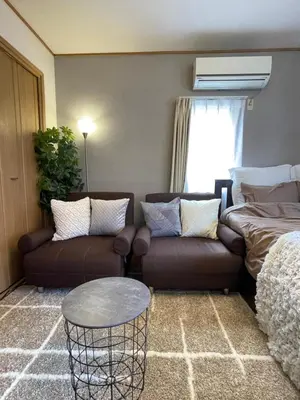 a living room with a couch and a bed at Best Shinjuku Modern Full-furnished Apartment1 ONLY 2min to Shinjuku by Train in Tokyo