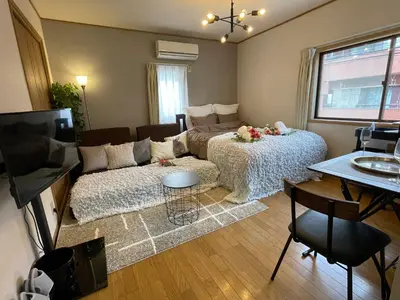 a living room with a bed and a couch at Best Shinjuku Modern Full-furnished Apartment1 ONLY 2min to Shinjuku by Train in Tokyo
