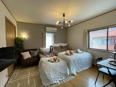 a living room with two beds and a couch at Best Shinjuku Modern Full-furnished Apartment1 ONLY 2min to Shinjuku by Train in Tokyo