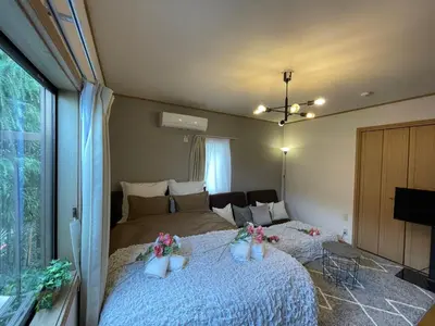 a bedroom with a bed with flowers on it at Best Shinjuku Modern Full-furnished Apartment2 ONLY 2min to Shinjuku by Train in Tokyo