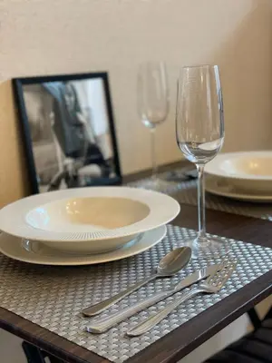 a table with a plate and a glass of wine at Best Shinjuku Modern Full-furnished Apartment2 ONLY 2min to Shinjuku by Train in Tokyo