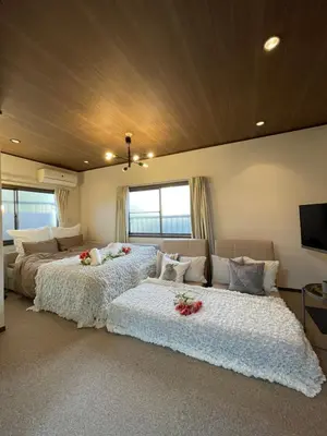 a bedroom with two beds with flowers on them at Best Shinjuku Modern Full-furnished Family size Apartment3 ONLY 2min to Shinjuku by Train in Tokyo