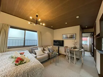 a bedroom with a bed and a living room at Best Shinjuku Modern Full-furnished Family size Apartment3 ONLY 2min to Shinjuku by Train in Tokyo