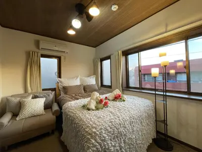 a bedroom with a bed with teddy bears and a couch at Best Shinjuku Modern Full-furnished Family size Apartment3 ONLY 2min to Shinjuku by Train in Tokyo