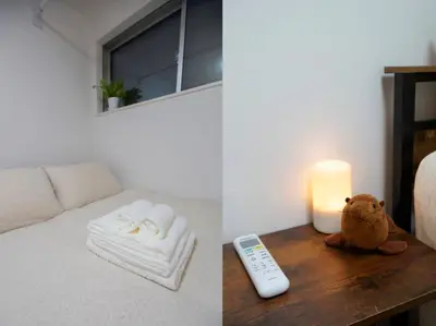 a bed with a remote control and a candle on a table at Skytree Cozy House in Tokyo