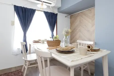 a dining room with a white table and chairs at CentralTokyo・Shinjuku/ 4BedRooms/8Beds / old style in Tokyo