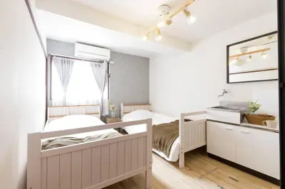 a bedroom with two bunk beds and a window at CentralTokyo・Shinjuku/ 4BedRooms/8Beds / old style in Tokyo