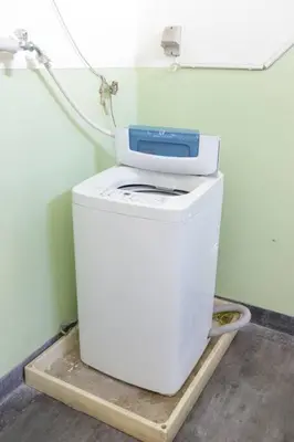 a washing machine sitting on top of a refrigerator at CentralTokyo・Shinjuku/ 4BedRooms/8Beds / old style in Tokyo