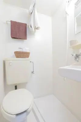 a white bathroom with a toilet and a sink at CentralTokyo・Shinjuku/ 4BedRooms/8Beds / old style in Tokyo