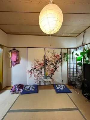 a room with blue mats and a chandelier at Shinjuku Shin-Okubo Station Nippon no Yado in Tokyo