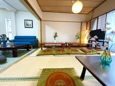 a living room with couches and a blue couch at Shinjuku Shin-Okubo Station Nippon no Yado in Tokyo