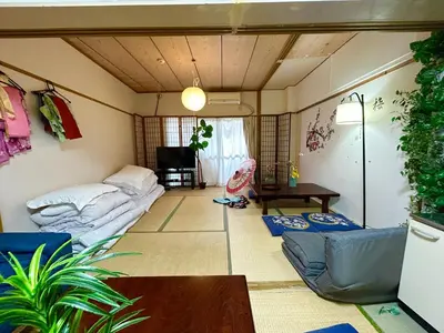 a living room with couches and a table in it at Shinjuku Shin-Okubo Station Nippon no Yado in Tokyo