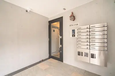 a hallway with a door leading into a room at Real Okubo Apartment Hotel in Tokyo
