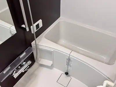 a white sink in a bathroom with a shower at Real Okubo Apartment Hotel in Tokyo