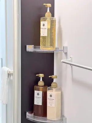 two bottles ofodorizers sitting on shelves in a bathroom at Real Okubo Apartment Hotel in Tokyo