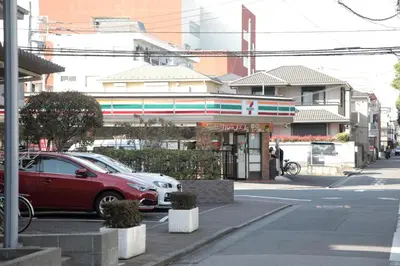 a red car parked in front of a building at \u30b2\u30b9\u30c8\u30cf\u30a6\u30b9\u6634 in Tokyo