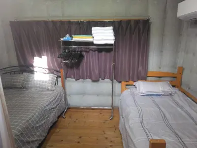 a small room with two beds and a window at Ikebukuro sta. 10mins walk. Rough style 88\u33a1 House in Tokyo