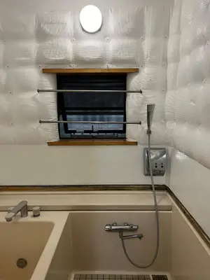 a bathroom with a bath tub with a shower at Ikebukuro sta. 10mins walk. Rough style 88\u33a1 House in Tokyo