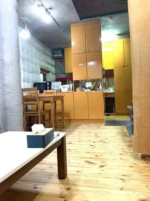 a large kitchen with yellow cabinets and a table at Ikebukuro sta. 10mins walk. Rough style 88\u33a1 House in Tokyo