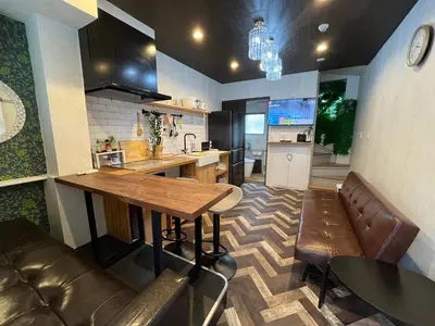 a kitchen with a wooden table and a counter top at \u6c60\u888bC1\u51fa\u53e3\u5f92\u6b695\u5206\u30002LDK \u307e\u308b\u307e\u308b\u8cb8\u5207\u3000\u885b\u751f\u8a2d\u5099\u5145\u5b9f in Tokyo