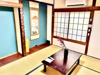 a room with a table with a vase on it at Budget 3-Bedrooms Villa#4mins to Ikebukuro#Hight speed wifi#Near Train Tracks in Tokyo