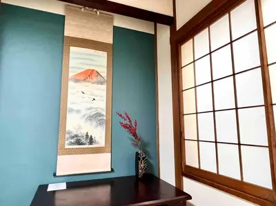a room with a vase on a table and two pictures at Budget 3-Bedrooms Villa#4mins to Ikebukuro#Hight speed wifi#Near Train Tracks in Tokyo