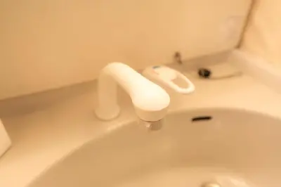 a white sink with a faucet in a bathroom at Budget 3-Bedrooms Villa#4mins to Ikebukuro#Hight speed wifi#Near Train Tracks in Tokyo