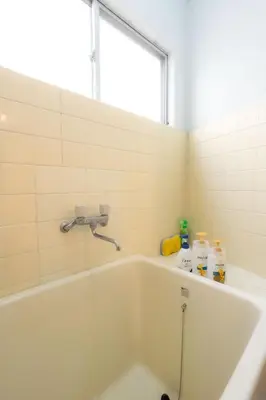 a white bath tub in a bathroom with a window at Budget 3-Bedrooms Villa#4mins to Ikebukuro#Hight speed wifi#Near Train Tracks in Tokyo