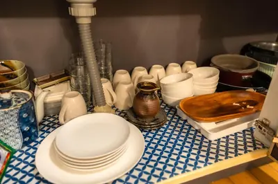 a counter with white plates and dishes on it at Budget 3-Bedrooms Villa#4mins to Ikebukuro#Hight speed wifi#Near Train Tracks in Tokyo