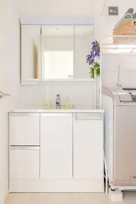 a white kitchen with a sink and a mirror at SKYTREE HOUSE in Tokyo