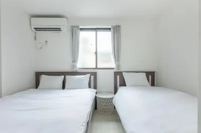 two beds sitting next to each other in a room at SKYTREE HOUSE in Tokyo