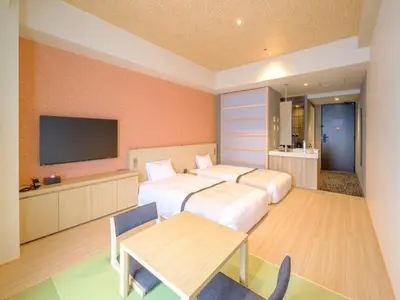 a hotel room with two beds and a television at Tosei Hotel Cocone Tsukiji Ginza Premier in Tokyo