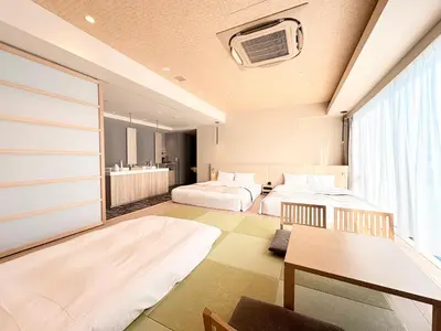 a hotel room with two beds and a table at Tosei Hotel Cocone Tsukiji Ginza Premier in Tokyo