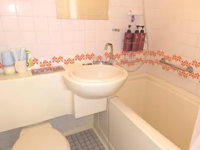 a bathroom with a sink and a toilet and a tub at B Shinjuku Self Check in in Tokyo