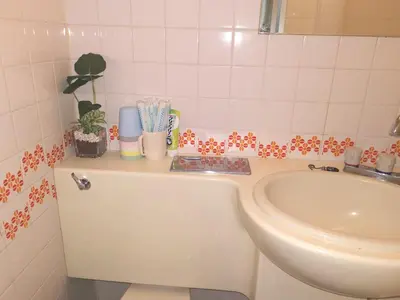 a bathroom with a toilet and a sink at B Shinjuku Self Check in in Tokyo