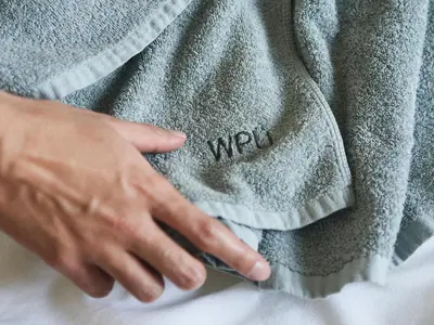 a man wearing a grey sweater with the word wilyn at WPÜ HOTEL Shinjuku in Tokyo
