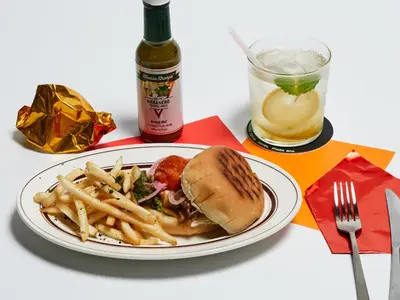 a plate with a sandwich and french fries and a drink at WPÜ HOTEL Shinjuku in Tokyo